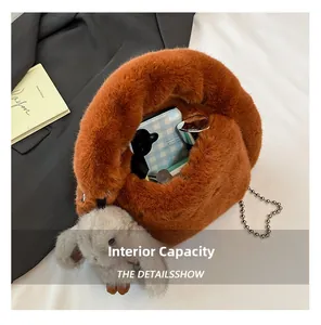 Fuzzy plush crossbody bag interior showing storage space for phone and cosmetics
