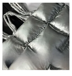 Close-up of metallic silver quilted tote bag with thick padding and glossy finish