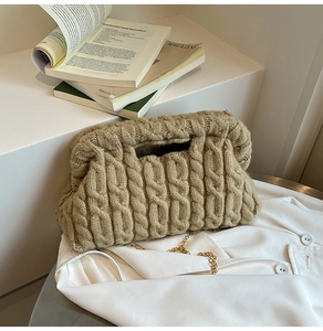 Detail of camel chunky knit cloud bag showing texture and gold chain strap