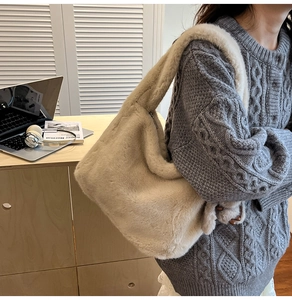 Detail view of large capacity beige plush shoulder bag with side zipper and fluffy strap