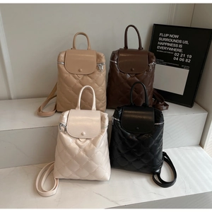 Quilted fashion backpacks in four colors displayed on tiered steps for urban style