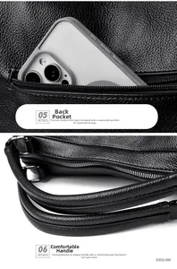 Detail view of black lychee grain leather handbag with rear zipper pocket and dual handles