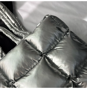 Close-up of metallic silver quilted tote bag showing high-shine fabric and puffy texture