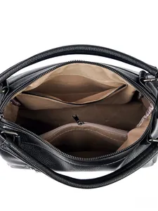 Internal view of large black lychee leather tote bag showing organized inner compartments