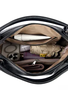 Interior view of black pebbled leather tote showing large capacity and internal pockets