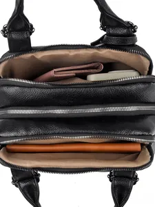 Interior view of black litchi pattern Boston bag with three zipper compartments and storage