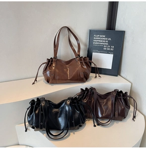 Detailed display of three stylish drawstring tote bags in brown, black, and coffee colors