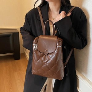 Brown quilted backpack with floral stitching and metal zipper for stylish daily use