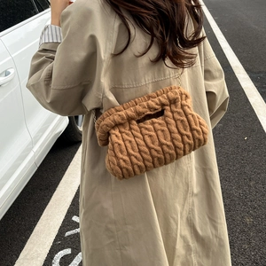 Brown chunky knit crossbody bag with cable stitch pattern and gold chain strap