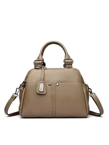 Close-up of pebble grain leather texture and vintage Boston bag metallic details