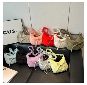 Detailed view of casual nylon crescent bags in ten various vibrant colors and bow details