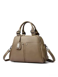 Close-up of premium lychee pattern leather and reinforced metal hardware on Boston bag