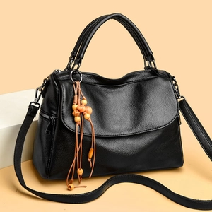 Black lychee leather handbag with wooden bead tassel and adjustable shoulder strap