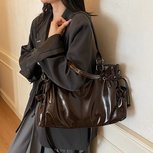 Glossy chocolate brown tote bag with side drawstring pockets and shoulder straps