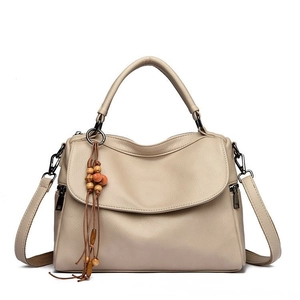 Beige lychee leather tote bag with wooden bead tassel on clean white background