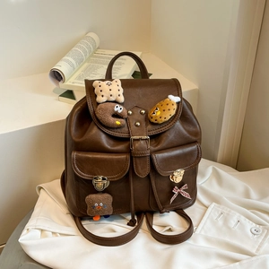Retro brown leather backpack with cute plush charms and multiple functional pockets