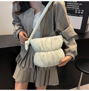 Detail of the pleated cloud bag featuring knotted straps and puffy nylon texture