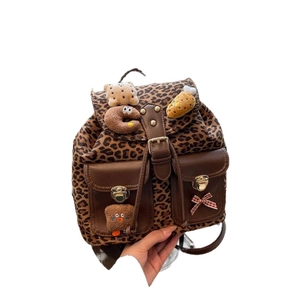 Leopard print canvas backpack with faux leather details and cute plush food charms