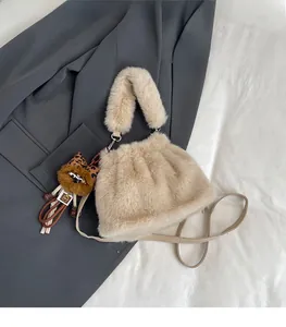 Close-up of fluffy faux rabbit fur handbag with a leopard print bear charm detail