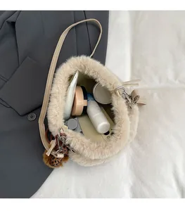 Internal view of plush bucket bag showing space for cosmetics and leopard print charm