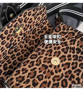 Detailed close-up of leopard print suede flap bag with gold magnetic buckle closure