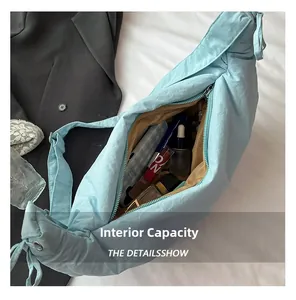 Spacious interior of the light blue nylon crossbody bag showing ample storage room