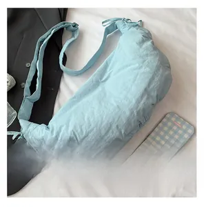 Detailed macro view of the light blue puffy dumpling bag featuring pleated fabric texture