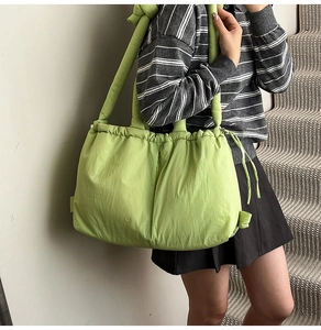 Close-up of lightweight lime green padded nylon bucket bag with drawstring closure