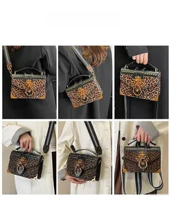 Leopard print crossbody bag detail showing lion head buckle and striped strap styles