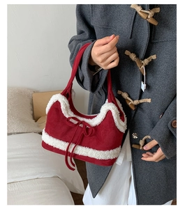Detail of red faux shearling tote bag with decorative bow and plush trim accents