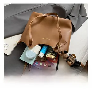 Interior view showing large capacity of the brown leather tote bag with iPad and items