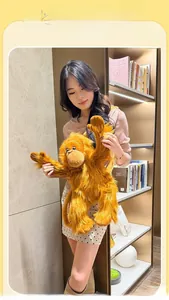 Close-up of a long-haired orangutan plush bag held by a model in a cozy library setting