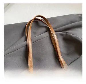 Close-up of adjustable brown leather straps with precise stitching and metal buckles