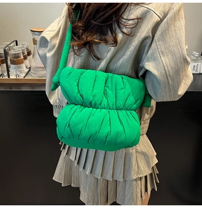 Detail of bright green ruched cloud bag showing puffer texture and quilted fabric material