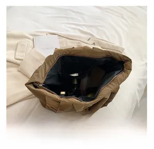 Spacious interior of brown quilted tote bag showing lining and storage compartments