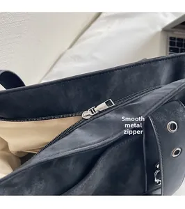 Detail of silver metal zipper and smooth slider on a premium black tote bag