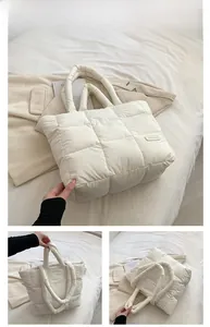 Close-up of white quilted puffer tote bag detail featuring the fashion textile label