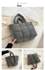 Detail of grey puffer tote bag with quilted nylon fabric and fashion logo on beige bedding