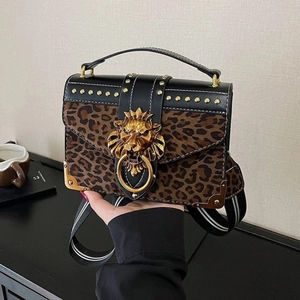 Suede leopard print square bag with golden lion head and wide striped shoulder strap