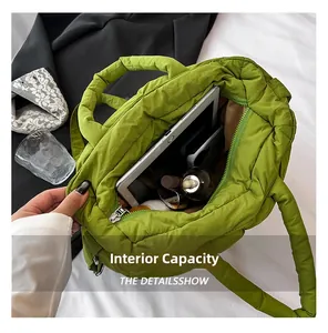 Macro view showing internal capacity of the green quilted tote bag with daily items