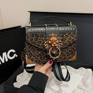 Vintage leopard print faux suede handbag with golden lion head buckle and woven strap