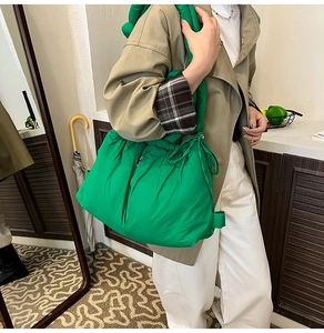 Bright green quilted puffy bucket bag shown in a lifestyle indoor scene for daily wear