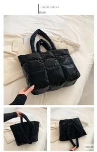 Detail view of black quilted puffer tote bag with fashion tag and soft padded texture