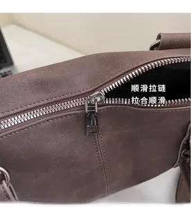 Close-up of smooth silver metal zipper on brown faux leather retro handbag