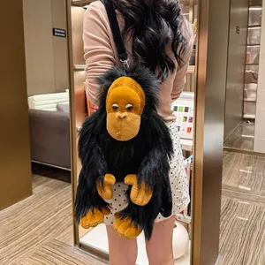 Detail of plush gorilla backpack with long yellow and black fur on a model's back