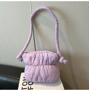 Close-up of lavender quilted cloud bag featuring stylish large knot details on the strap