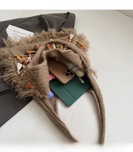 Macro shot of large capacity knit tote bag showing interior space and tassel details