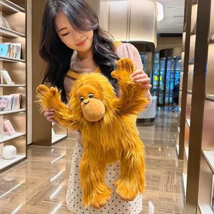 Close-up of fluffy long-haired orangutan plush bag with soft orange fur texture
