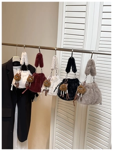 Row of plush drawstring handbags in five colors with cute cartoon animal charms