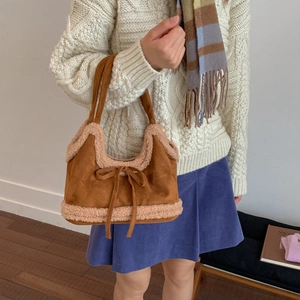 Brown suede tote bag with cream fleece trim and bow knot detail for autumn winter style